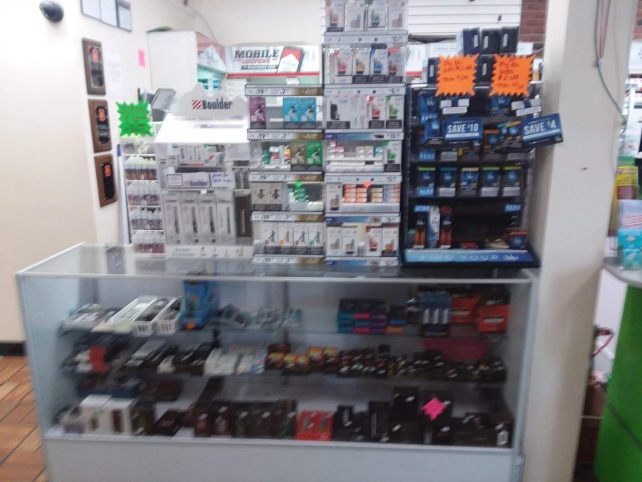 A display stand of various vaping products at a gas station.
