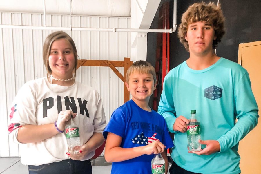 Bria, Gage, and Jhett proudly posing with their coveted Sprite Cranberry bottles.