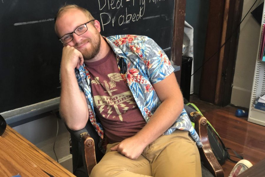 Mr. Parr dons a gray tropical shirt with vibrant blue and red flowers. 