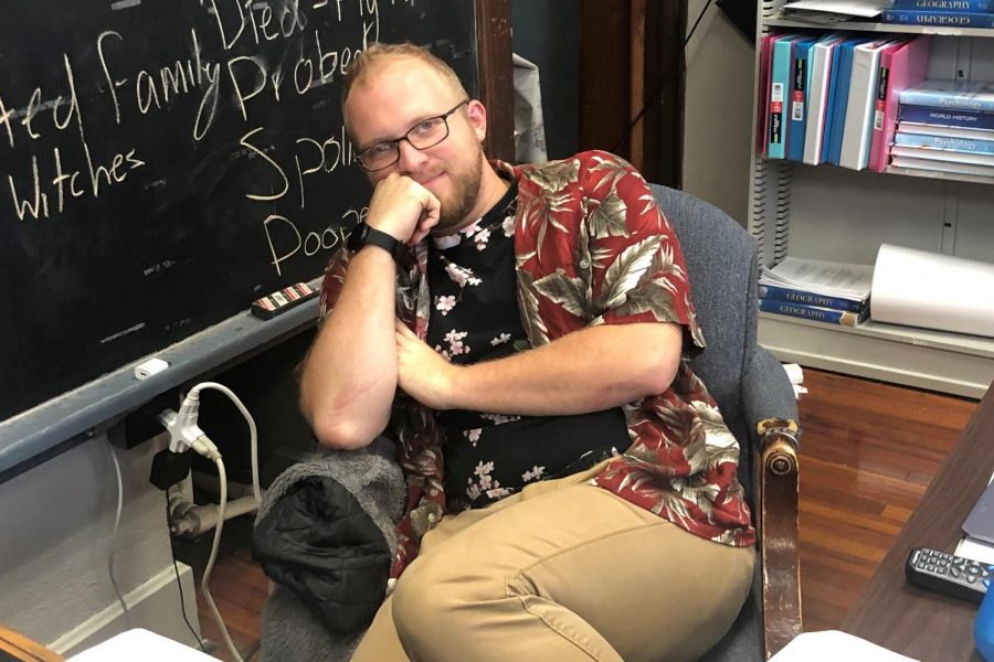 Mr. Parr wears a deep red tropical shirt with a palm leaf print, complimented by a black, flower print t-shirt.