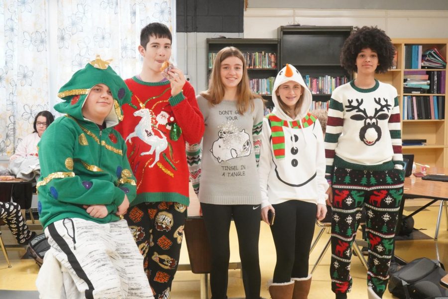 Some of our eighth grade Ugly Holiday Sweater contest entries, including first place winner Carter (far left).