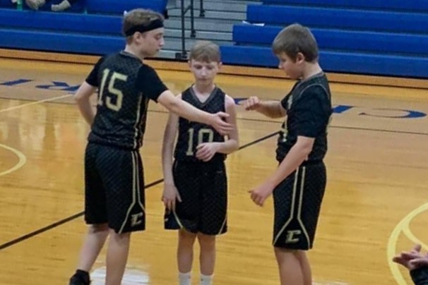 Rylan, Caleb, and Gage get ready to start the game.