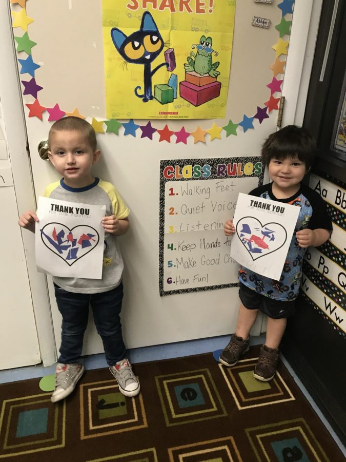 Two of our preschool students show off their artwork in honor of our Veterans.