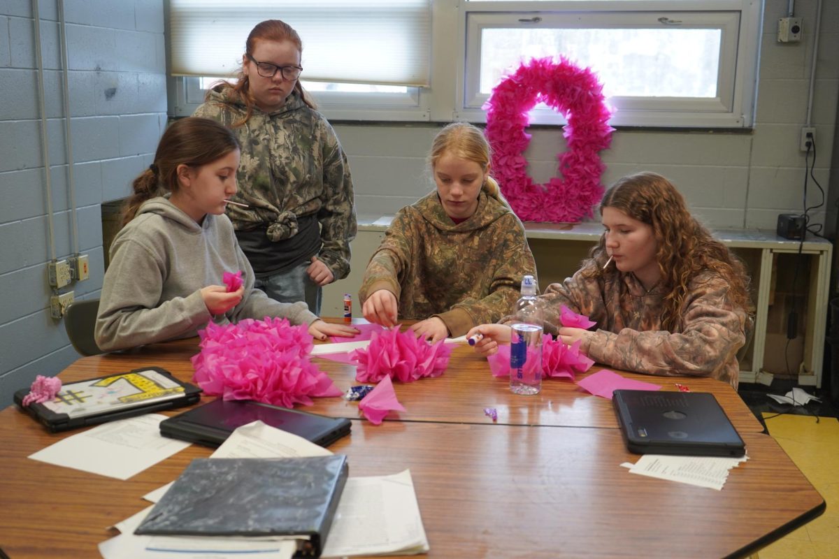 A group of middle school students work on decorations for this year's dance.
